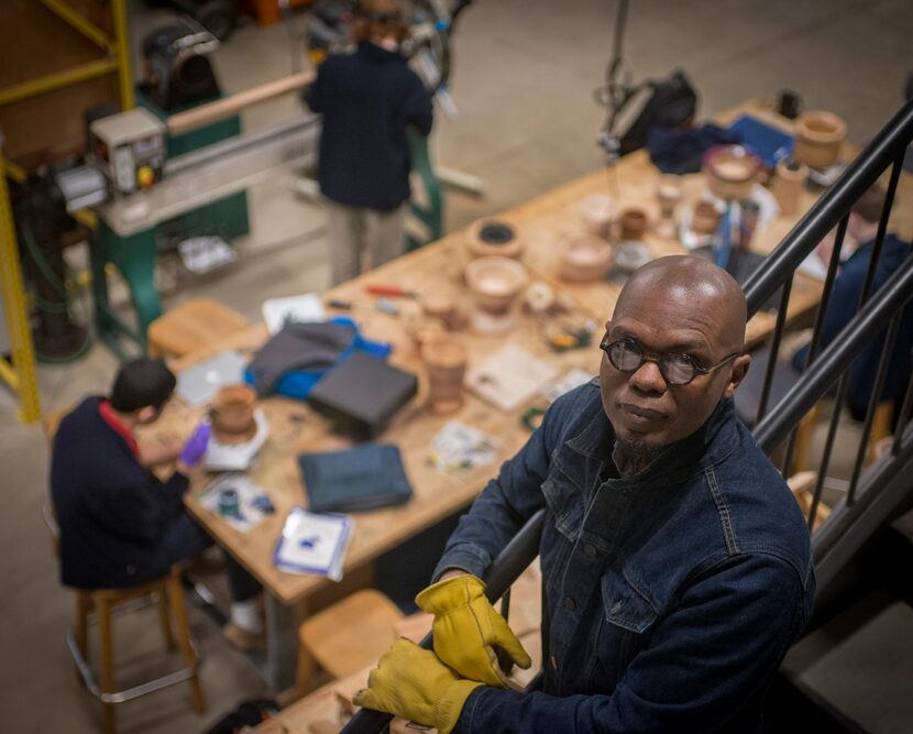 Sculptor Emmanuel Gillespie in the studio at the Winston School with his students, who are...