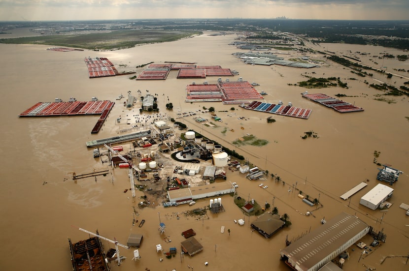 Barges were secured by tugboats in flood-swollen Burnet Bay along the Houston Ship Channel...