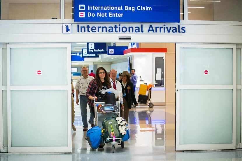 
Danielle Banks exits through the doors into the international arrivals hall after 20 hours...