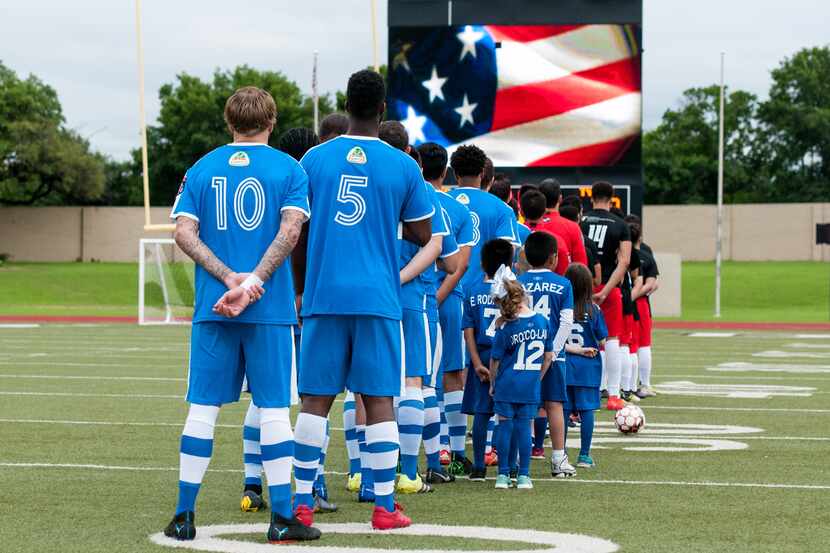 Fort Worth Vaqueros stand for the National Anthem at a home game against Tyler FC.