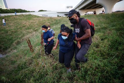 Protesters running from popping sounds near Interstate 35 on the west side of downtown...