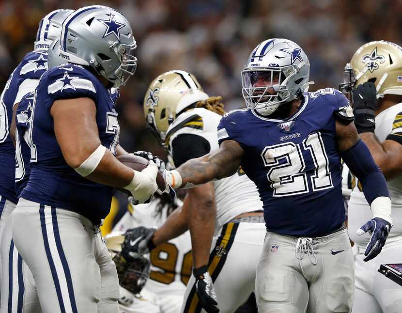 Dallas Cowboys running back Ezekiel Elliott (21) hands the ball to Dallas Cowboys offensive...