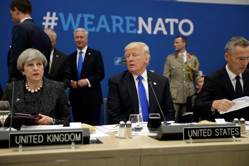 U.S. President Donald Trump (center) is flanked by British Prime Minister Theresa May and...