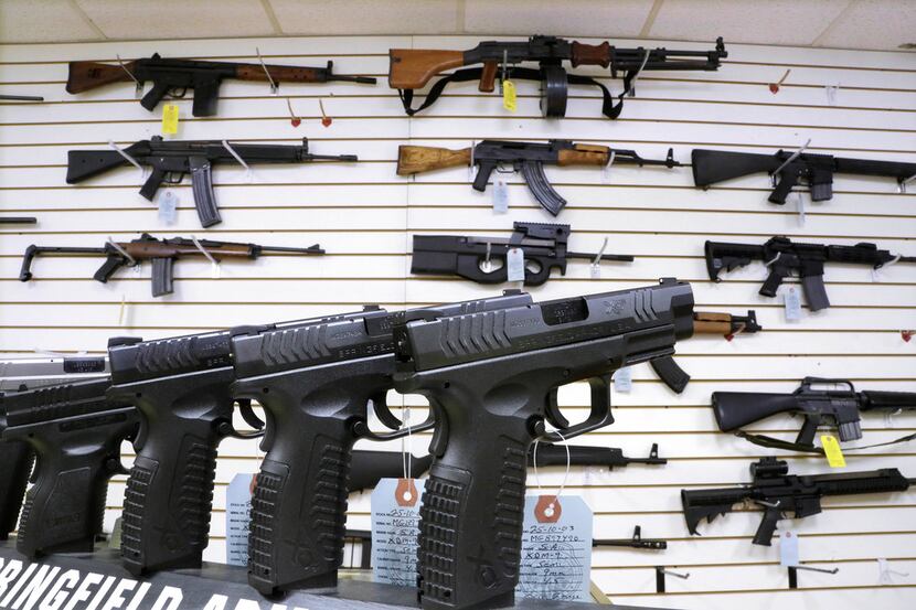 Assault weapons and hand guns are seen for sale at Capitol City Arms Supply in Springfield,...