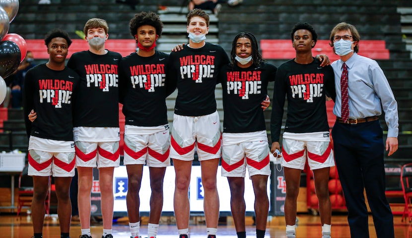 Lake Highlands senior forward Mohamad Shamait, center, poses for photographs with his...