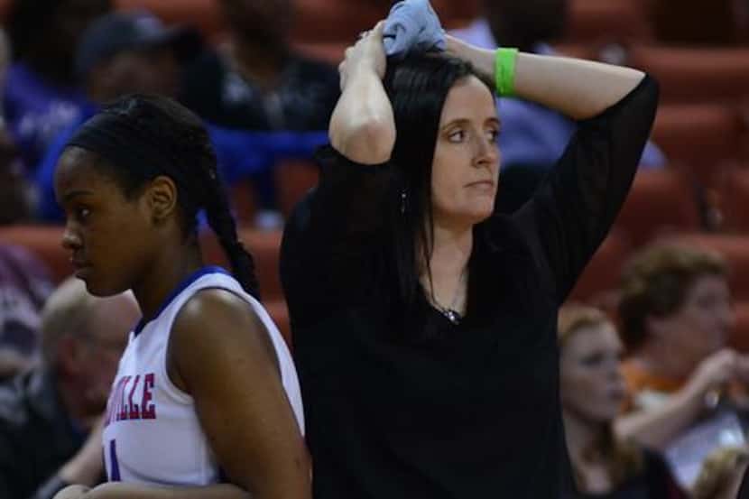Duncanville assistant coach Elisha Walker watches in dismay as yet another foul is called in...
