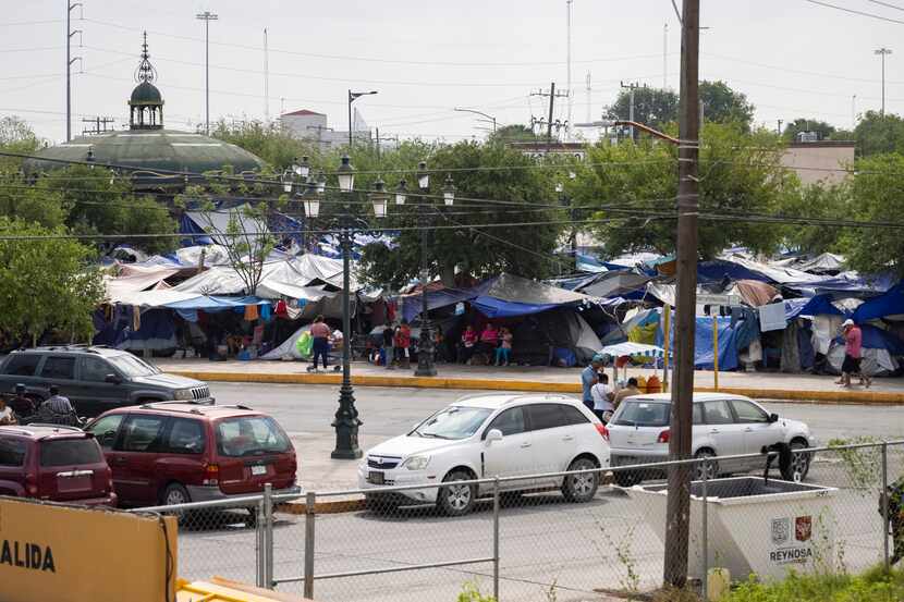Tents and tarps set up by migrants staying at a public square in the Mexican border city of...