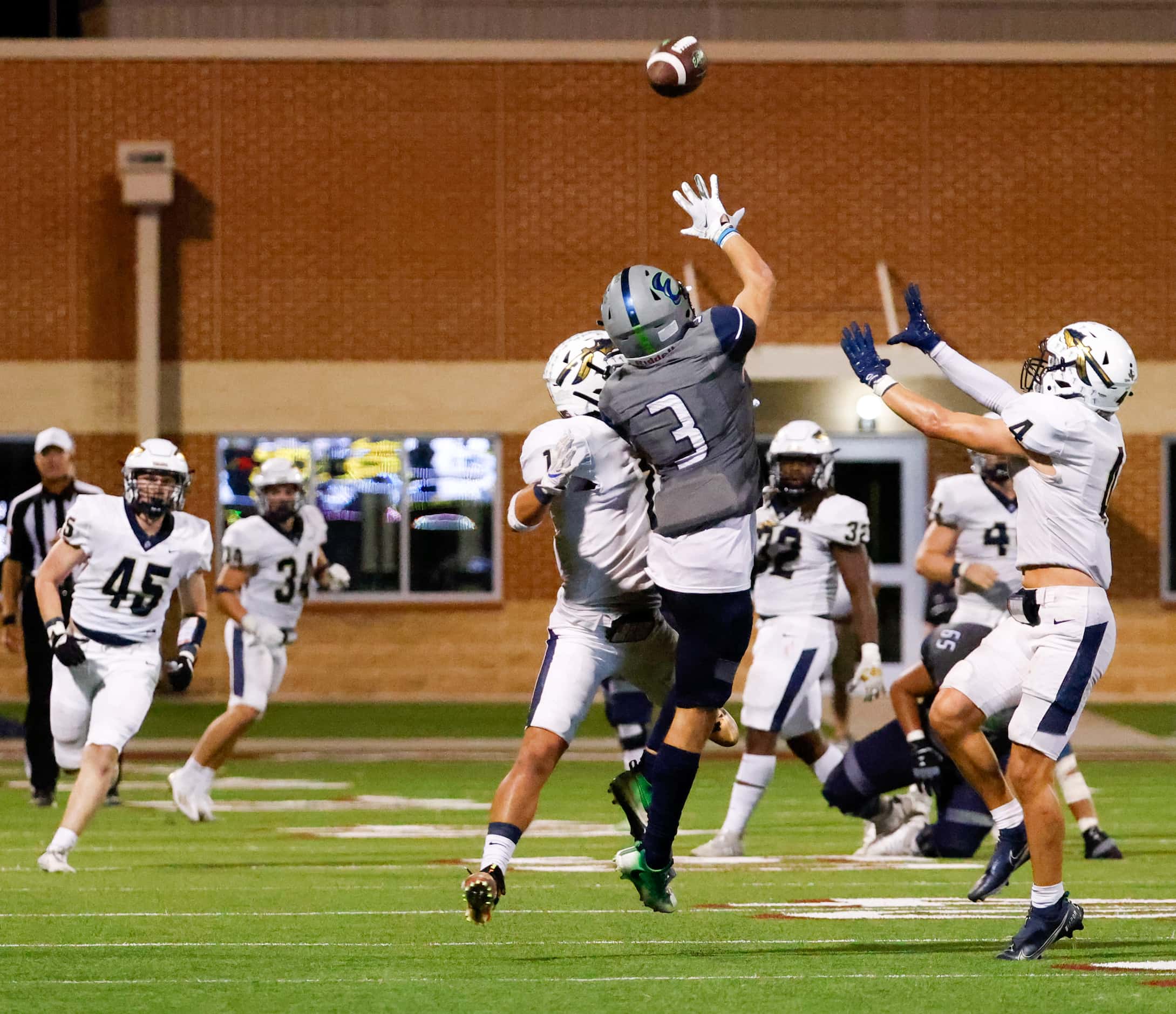 V.R. Eaton High School wide receiver Talan Holmes (3) reaches for a pass during the fourth...