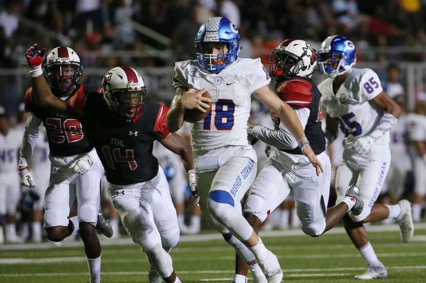 Cedar Hill players are unable to reach Bishop Gorman quarterback Tate Martell (18) as...