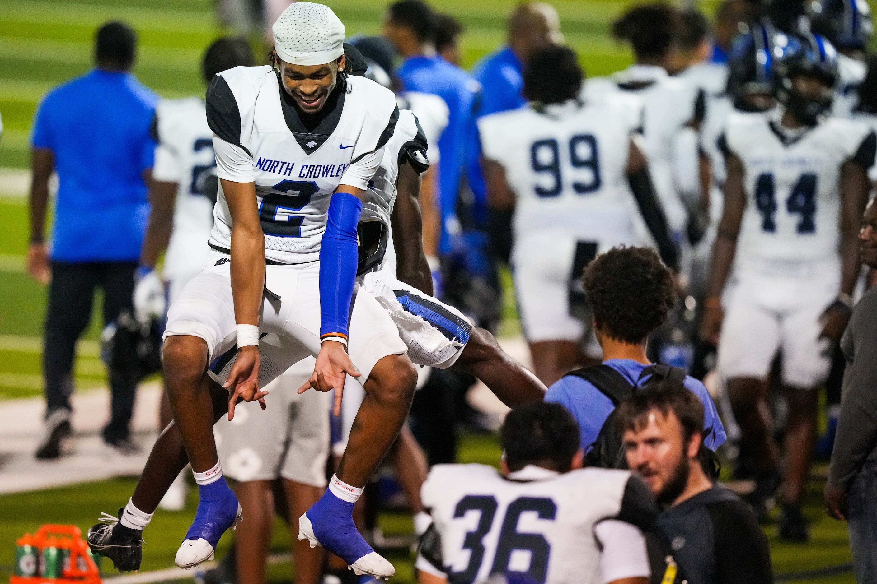 North Crowley linebacker Jonathan Cunningham (2) celebrates with teammates on the sidelines...