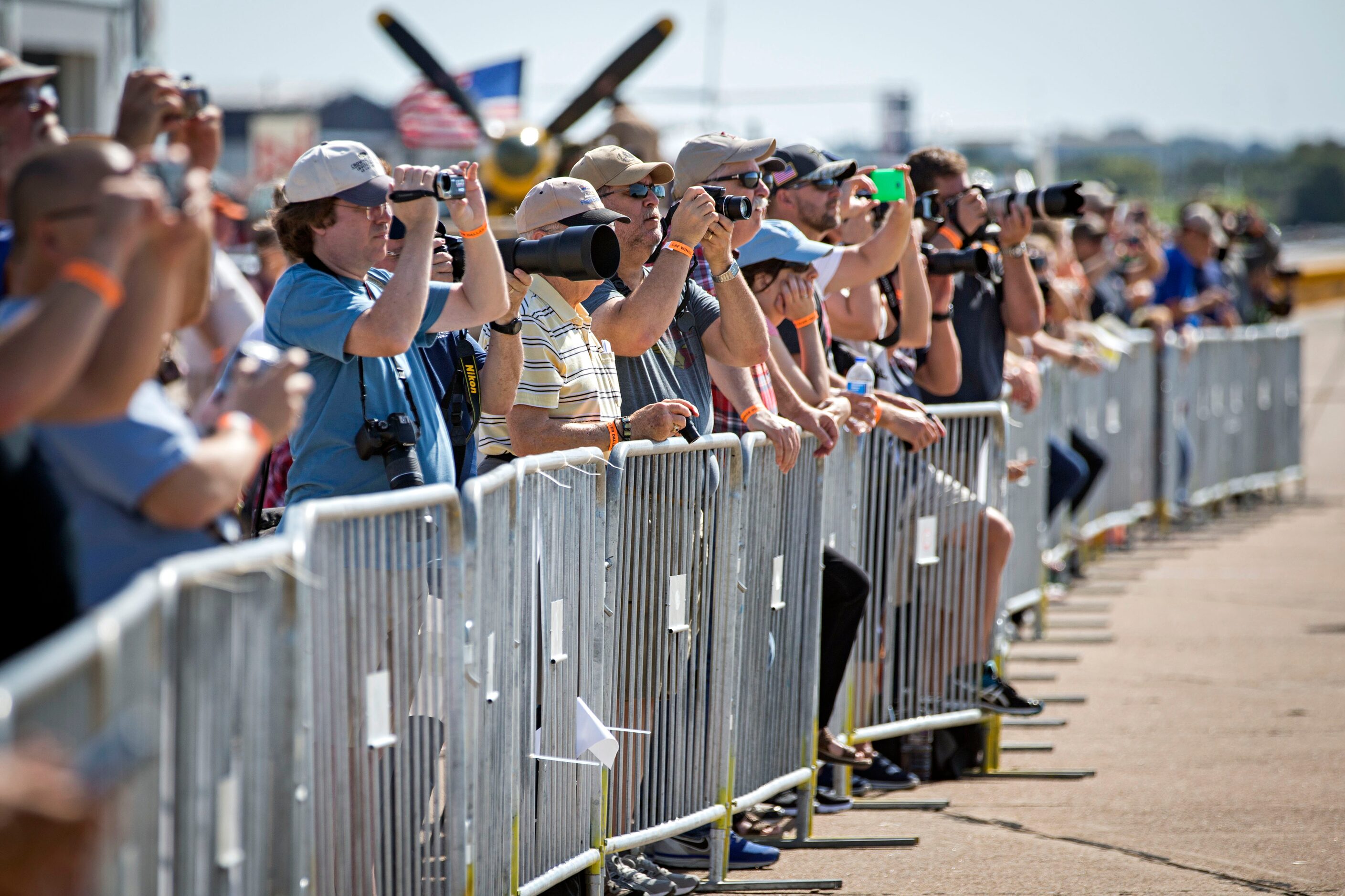 People snap photos and record video during the Commemorative Air Force Wings Over Dallas...