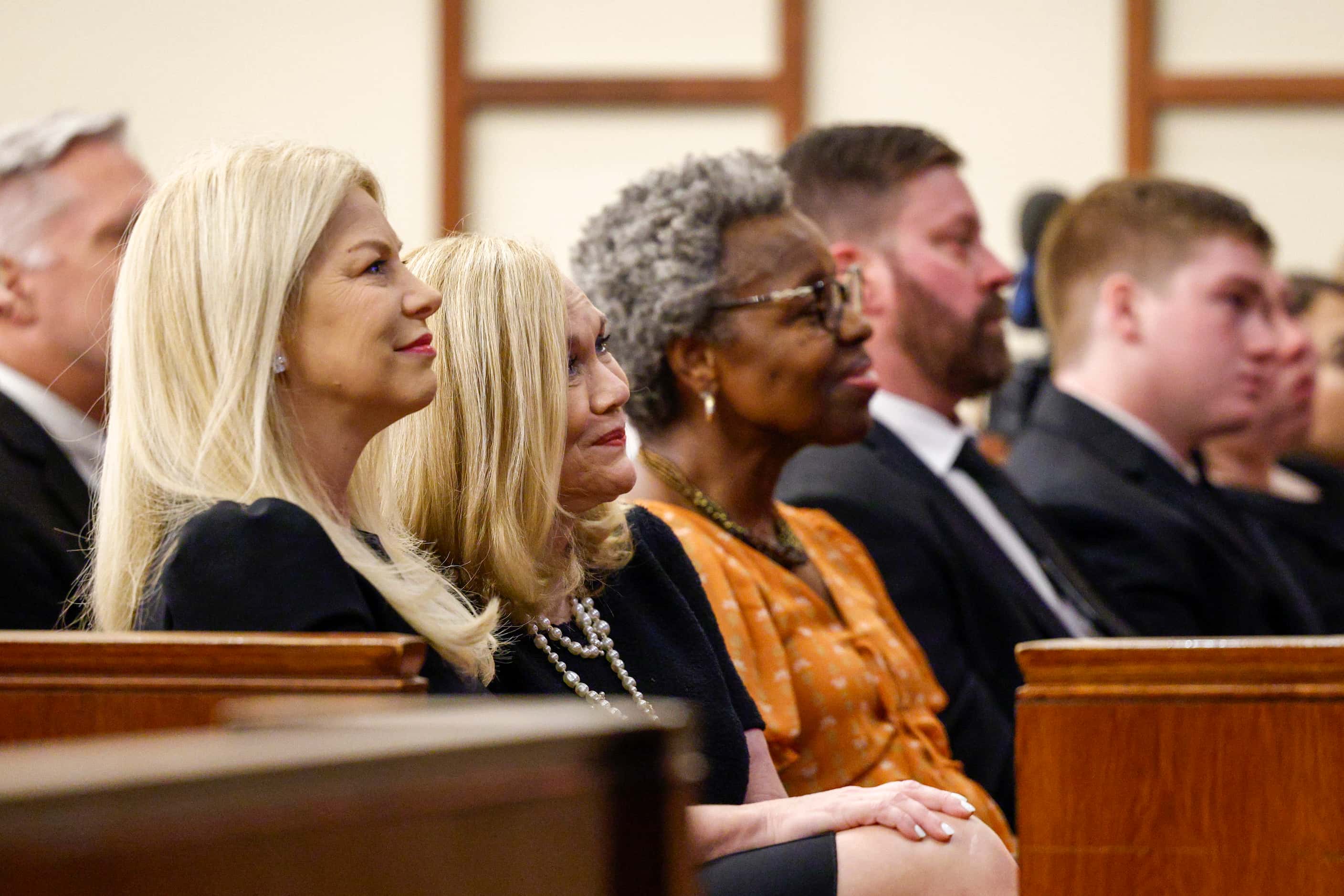 Sarah Dodd (left) listens to a eulogy alongside her mother Vicki Dodd during a funeral...