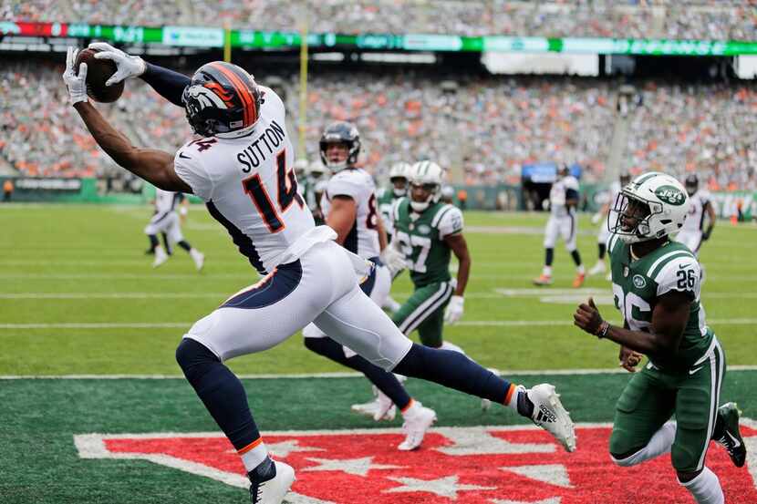 Denver Broncos' Courtland Sutton (14) catches a pass for a touchdown during the first half...