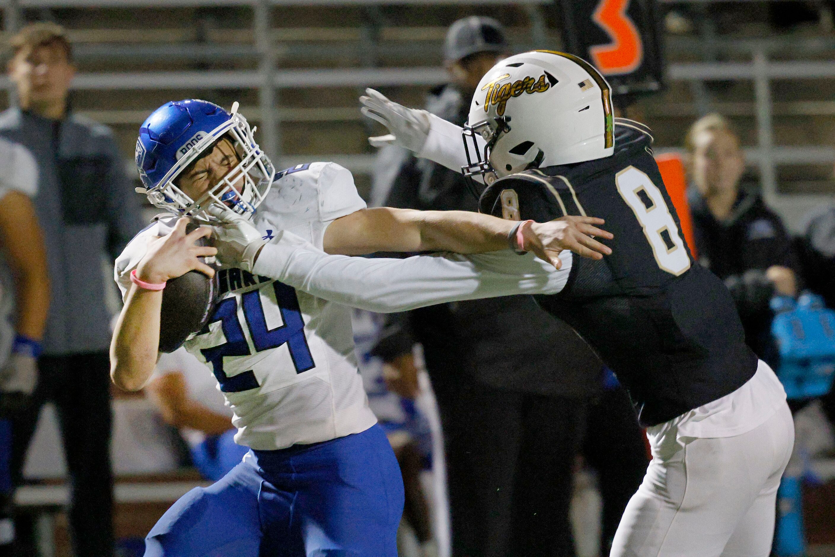 Weatherford's Xavier Craven (24) is tackled by Mansfield's Kameron Johnson (8) in the second...