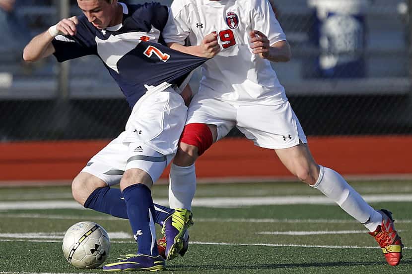 Wakeland High School's Corey Cantor (7) battles for the soccer ball against Centennial High...