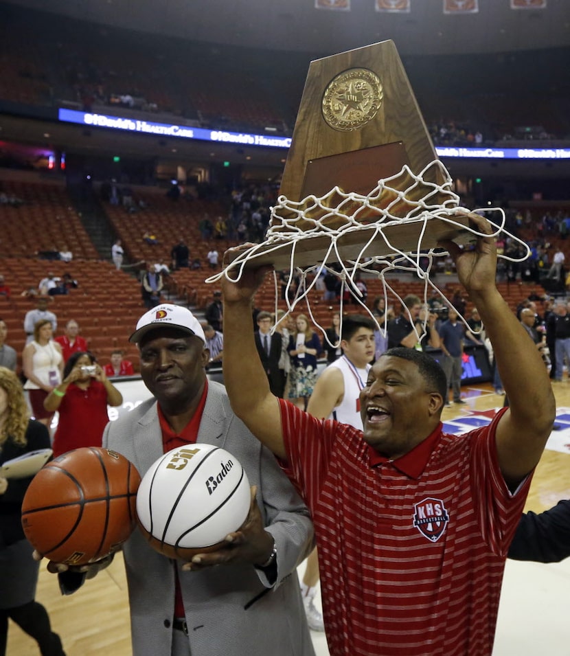 Kimball coach Royce Johnson, holds  the boys basketball Class 4A boys basketball state...