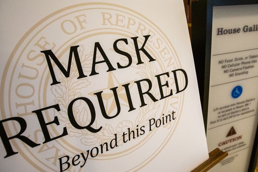 Signage enforcing mask usage outside the House Gallery of the Texas State Capitol in Austin,...