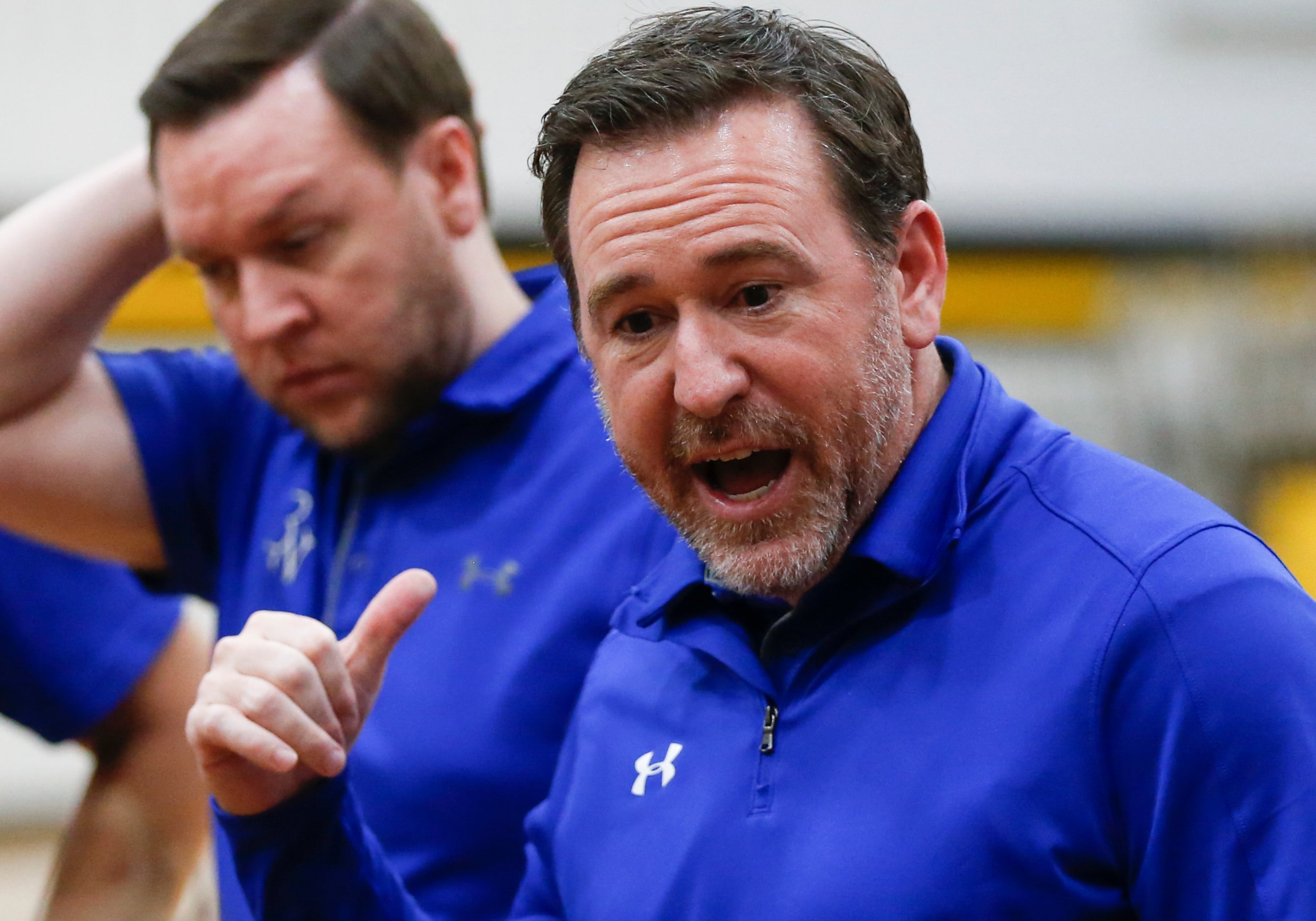 Byron Nelson High School head coach Scott Curran talks to players during a break in play in...