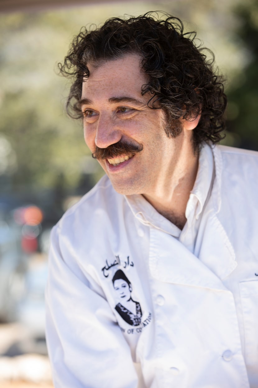 Nasher Prize winner Michael Rakowitz works his booth during a barbecue event in partnership...