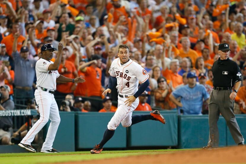 HOUSTON, TX - OCTOBER 12:  George Springer #4 of the Houston Astros rounds the bases to...