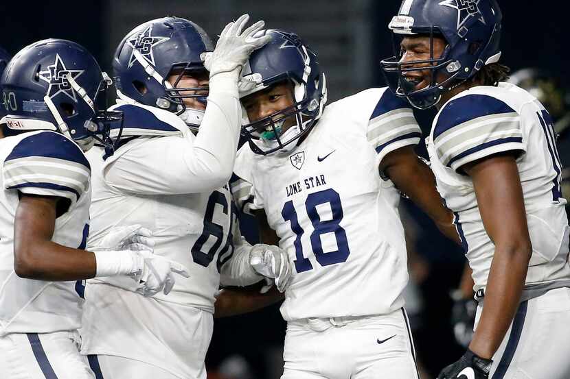 Frisco Lone Star's Marvin Mims (18) is congratulated by Reese Cory (66), Kavika Pittman (10)...