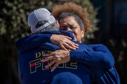 Sibyl Washington embraces DeSoto Fire Captain Craig Kirk following the aftermath of a house...