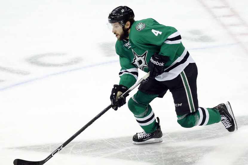 Dallas Stars defenseman Jason Demers (4) brings the puck up the ice in the third period...