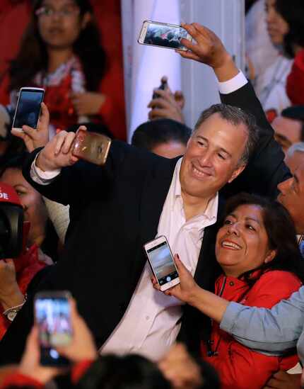 Jose Antonio Meade posed for selfies with supporters as he arrived for an event celebrating...