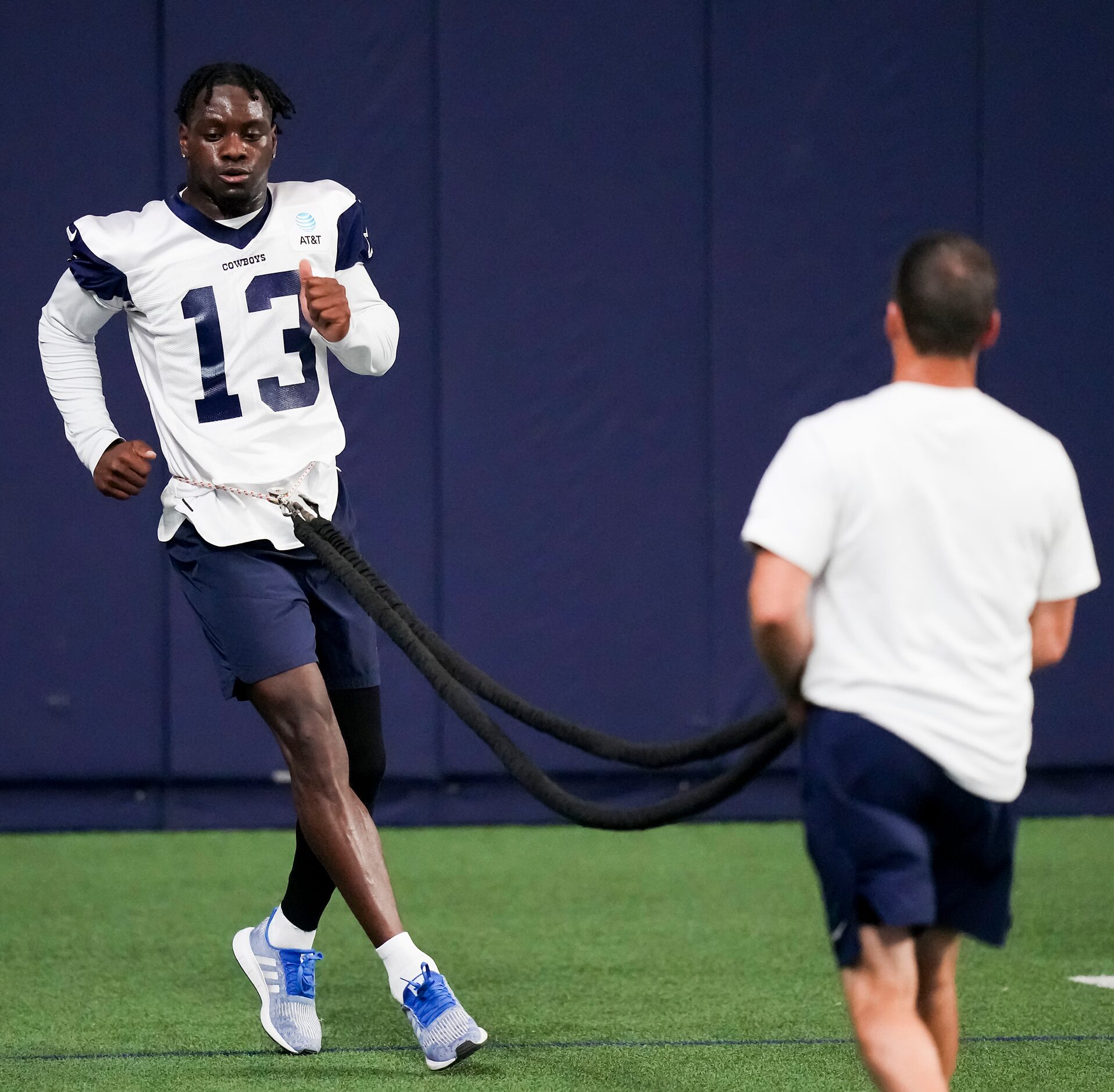 Dallas Cowboys wide receiver Michael Gallup works with a resistance band during the OTA...