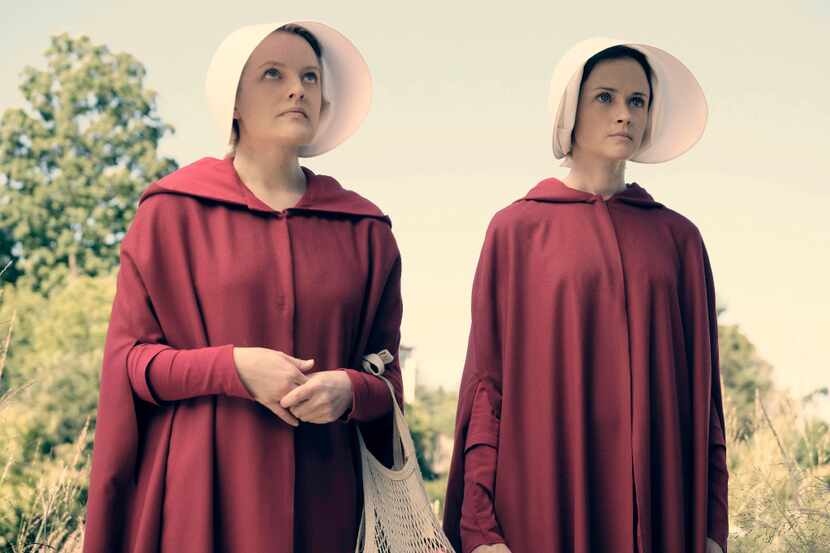 (L-r) Elisabeth Moss as Offred and Alexis Bledel as Ofglen in the Hulu series "The...