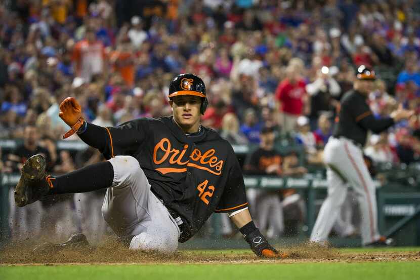 Baltimore Orioles third baseman Manny Machado slides home with a run during the seventh...