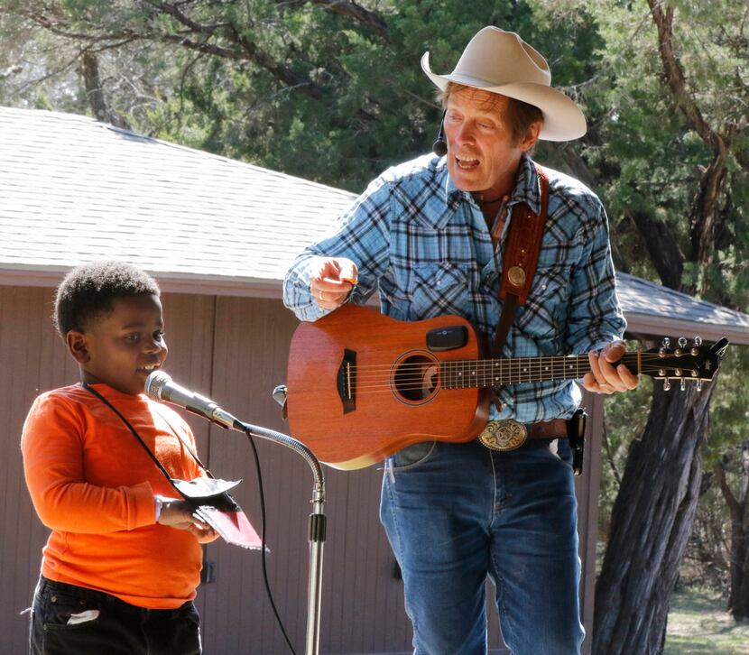 Samuel Bedford takes the stage to help out "Cowboy Bob" Ackerman  during Cowboy Camp in...