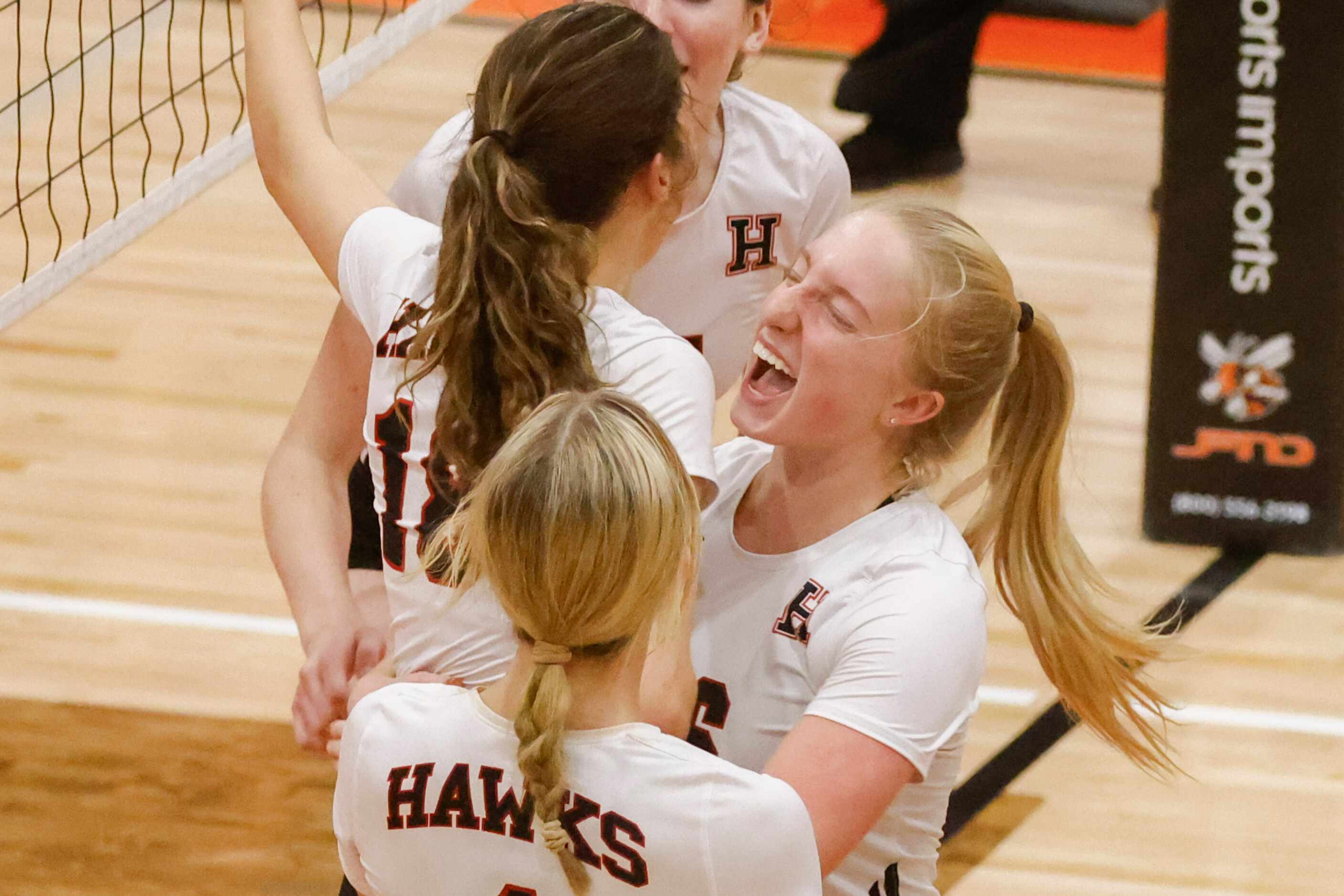Rockwall Heath’s Abby Lemp (left), and Logan Younger cheer after a point during a volleyball...