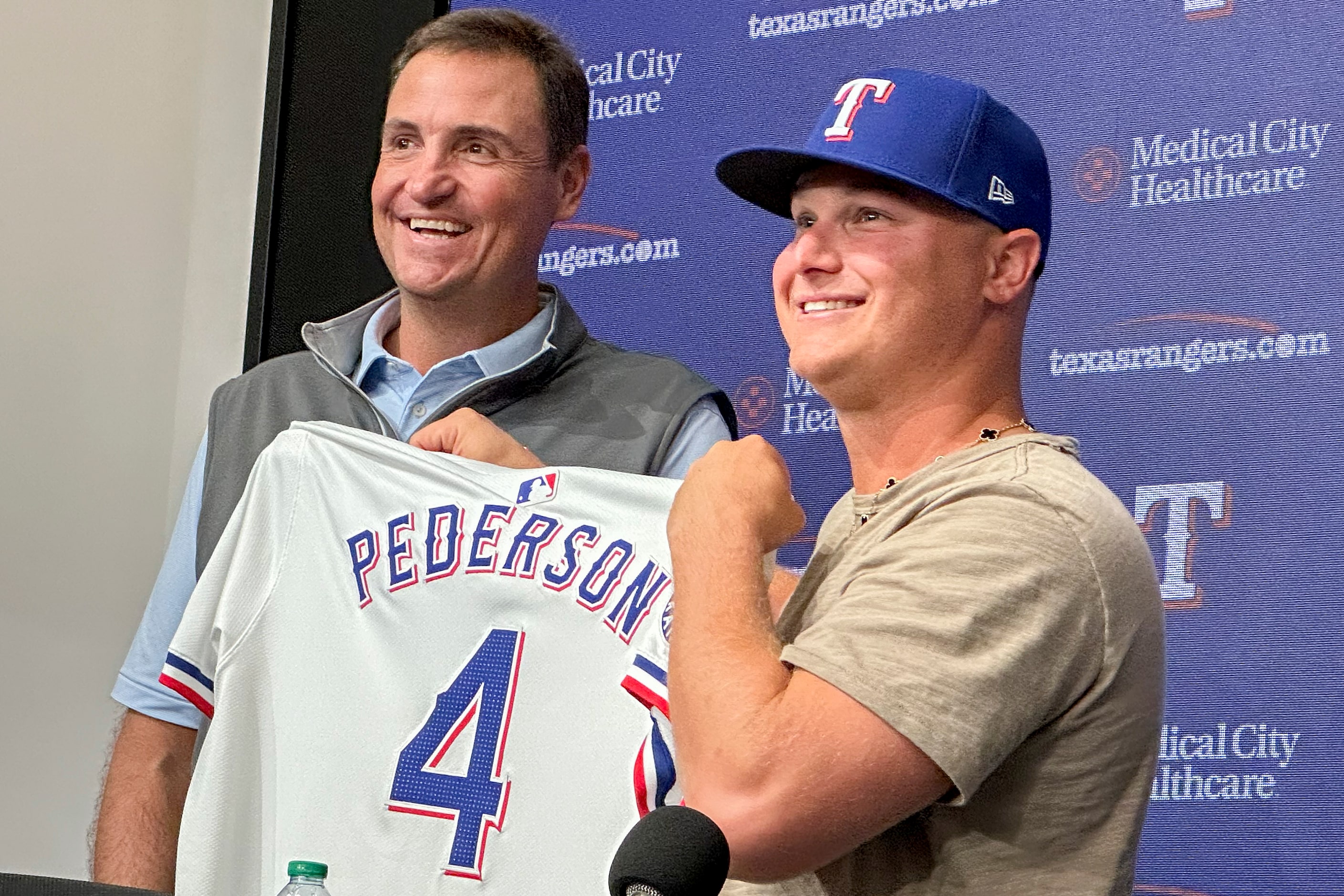 Texas Rangers president of baseball operations Chris Young, left, poses for photos with Joc...