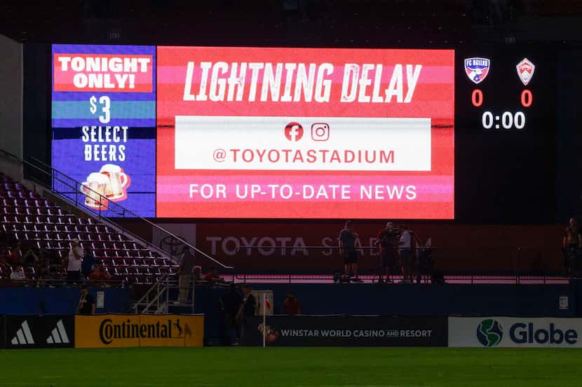 A video board shows a message during a lightning delay before an MLS game between FC Dallas...