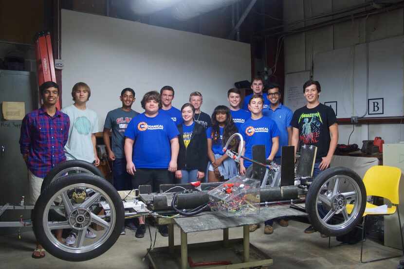  UTD students with the chassis of the vehicle they will enter in the Shell Eco-marathon...