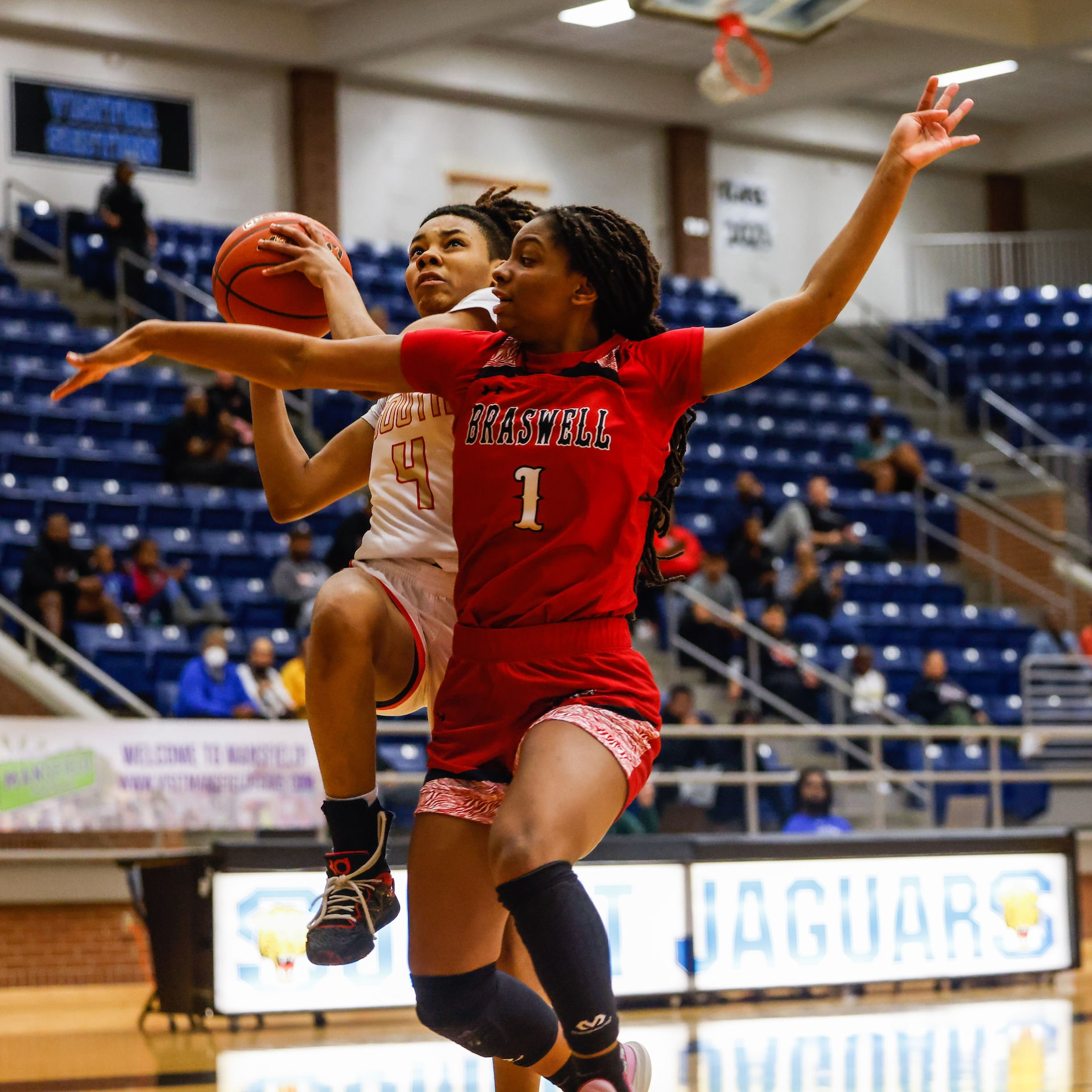 South Grand Prairie's Joy Madison-Key (4) goes for a shot as Denton Braswell's Spirit...