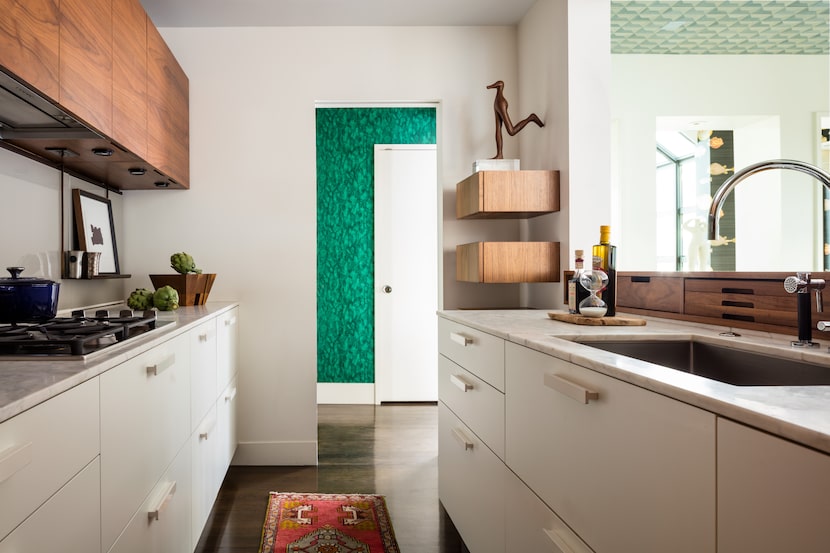 A white kitchen has lower drawer space.