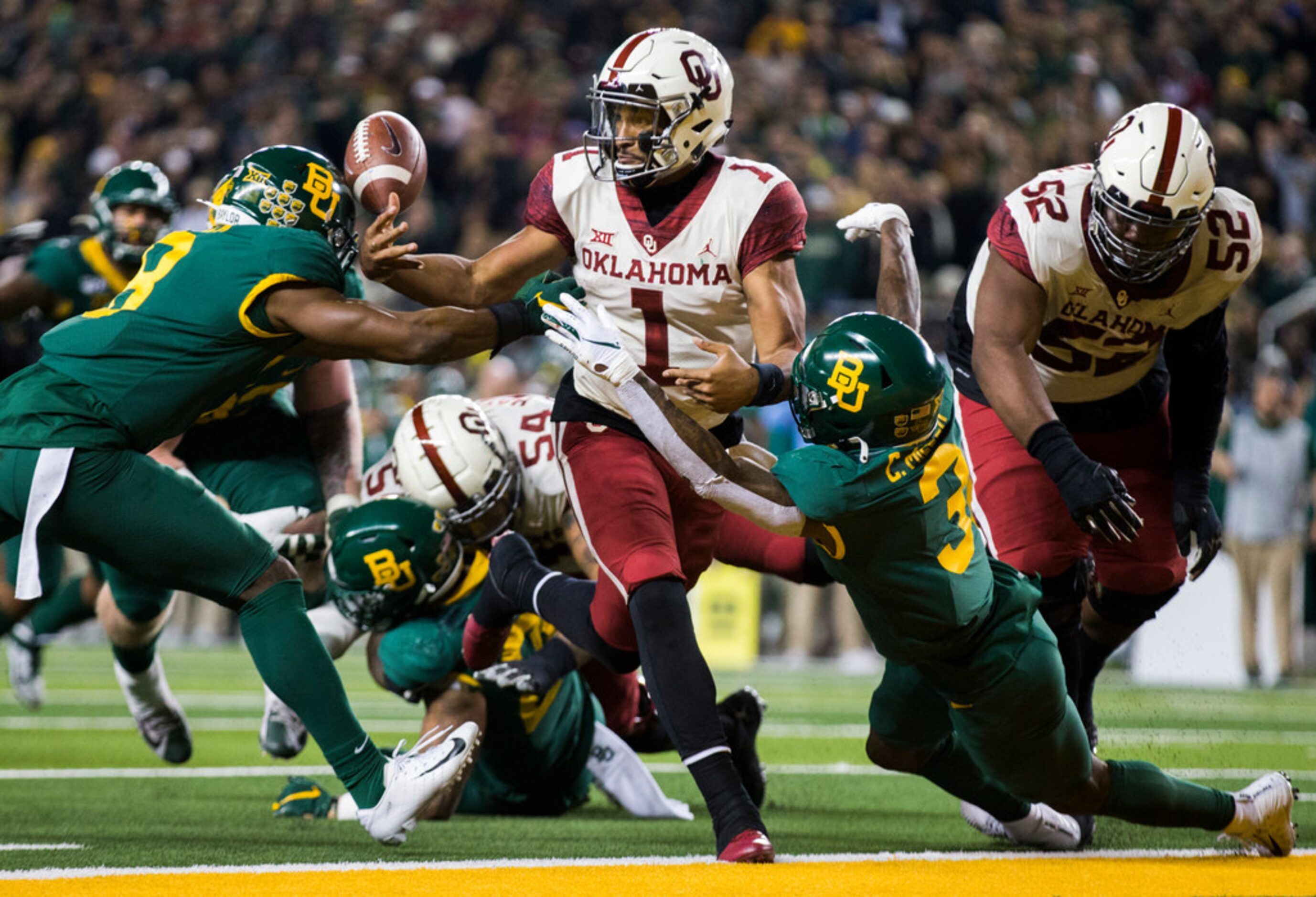 Oklahoma Sooners quarterback Jalen Hurts (1) fumbles the ball at the half yard line as he...