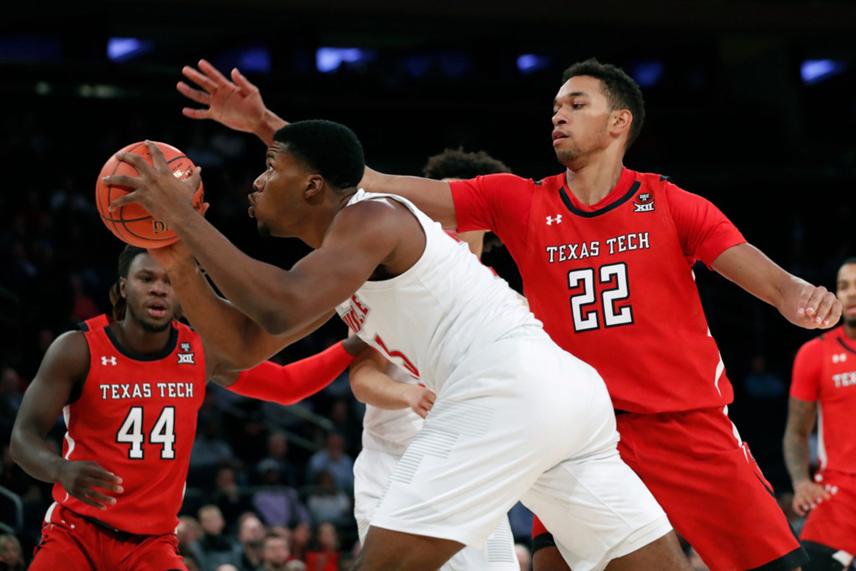 Texas Tech forward TJ Holyfield (22) defends Louisville forward Jordan Nwora, center, during...