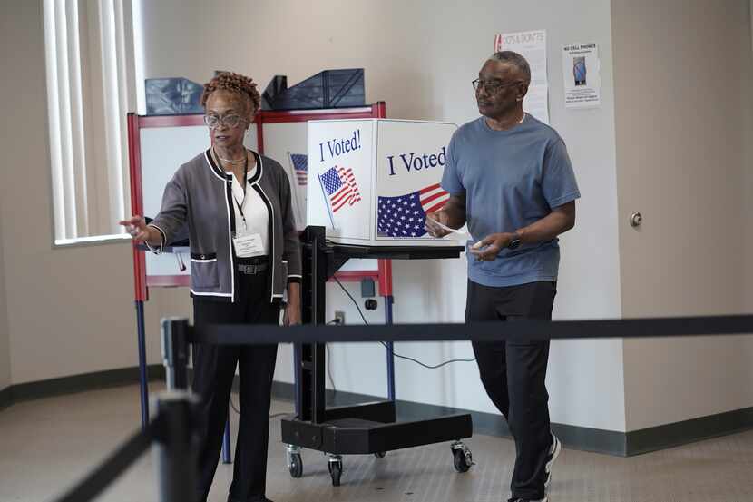 Joseph Clarkson Sr., 72, takes his ballot to a scanner during the South Carolina Democratic...