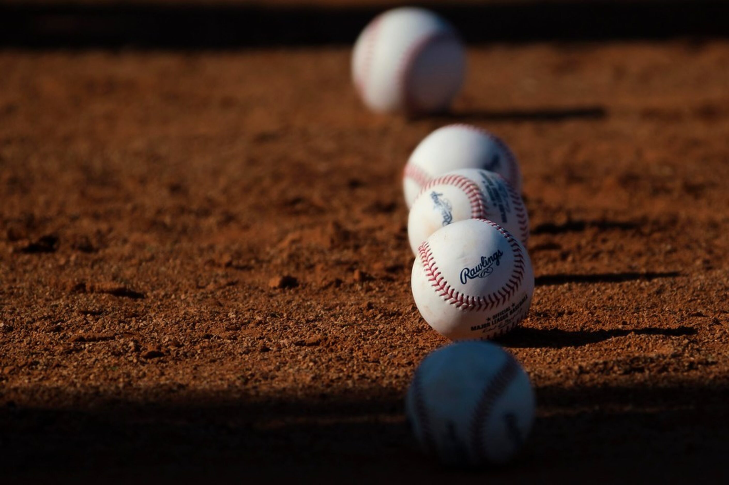 Baseballs are lined jup for a catching drill during a Texas Rangers spring training workout...