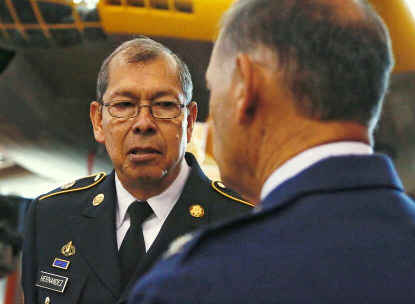 Command Sgt. Maj. Juan Hernandez (left) visits with retired Air Force Col. Joe Cordina...