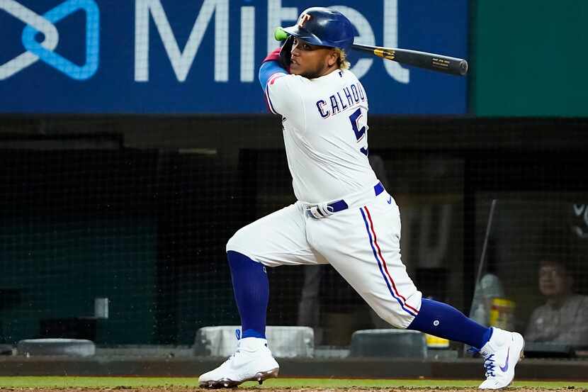 Texas Rangers designated hitter Willie Calhoun singles during the ninth inning against the...