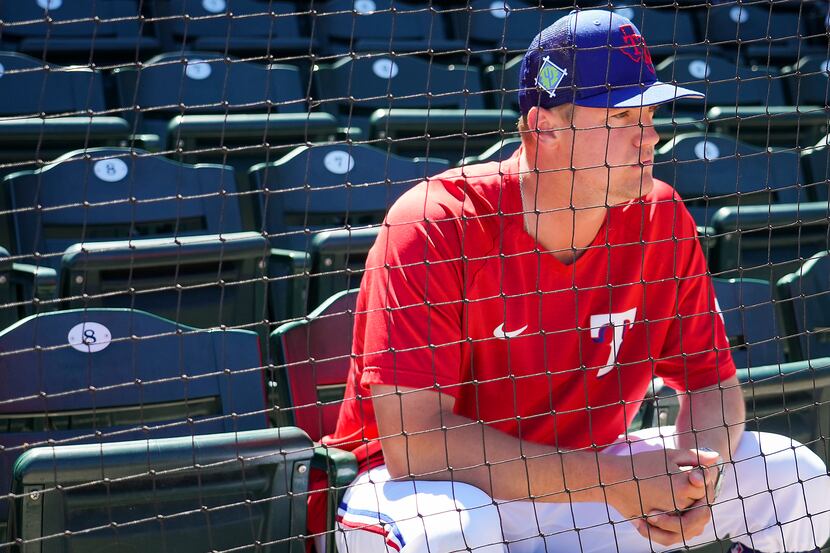 Texas Rangers infielder Josh Jung watches from the stands before a spring training game...