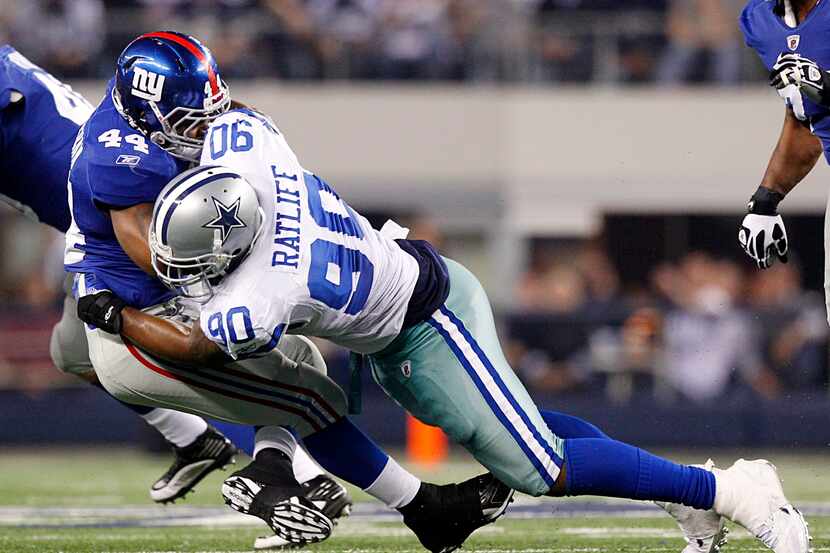 Dallas Cowboys nose tackle Jay Ratliff (90) lays a big hit on New York Giants running back...