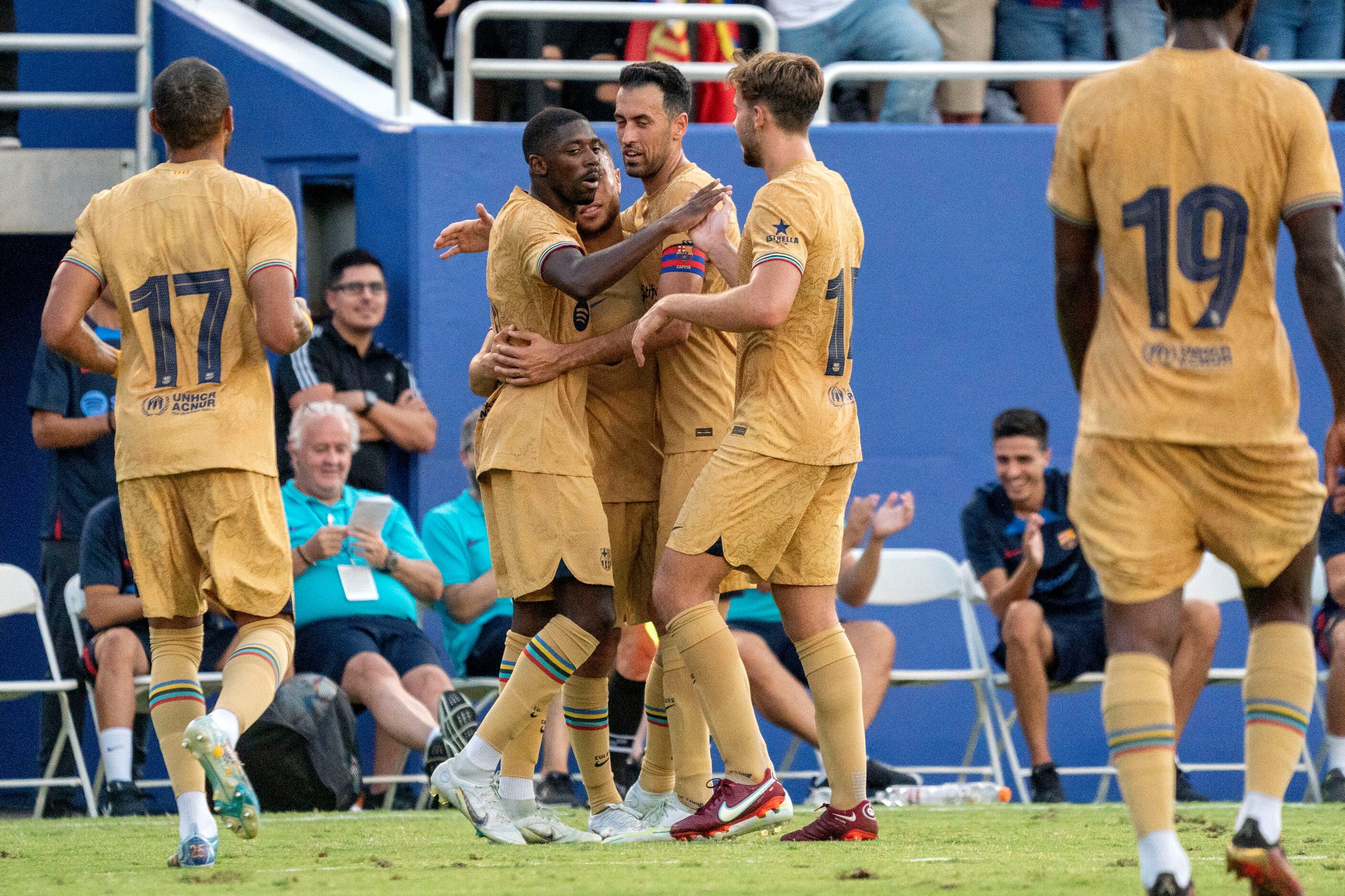 Barcelona forward Ousmane Dembélé, center, is congratulated by teammates after scoring his...