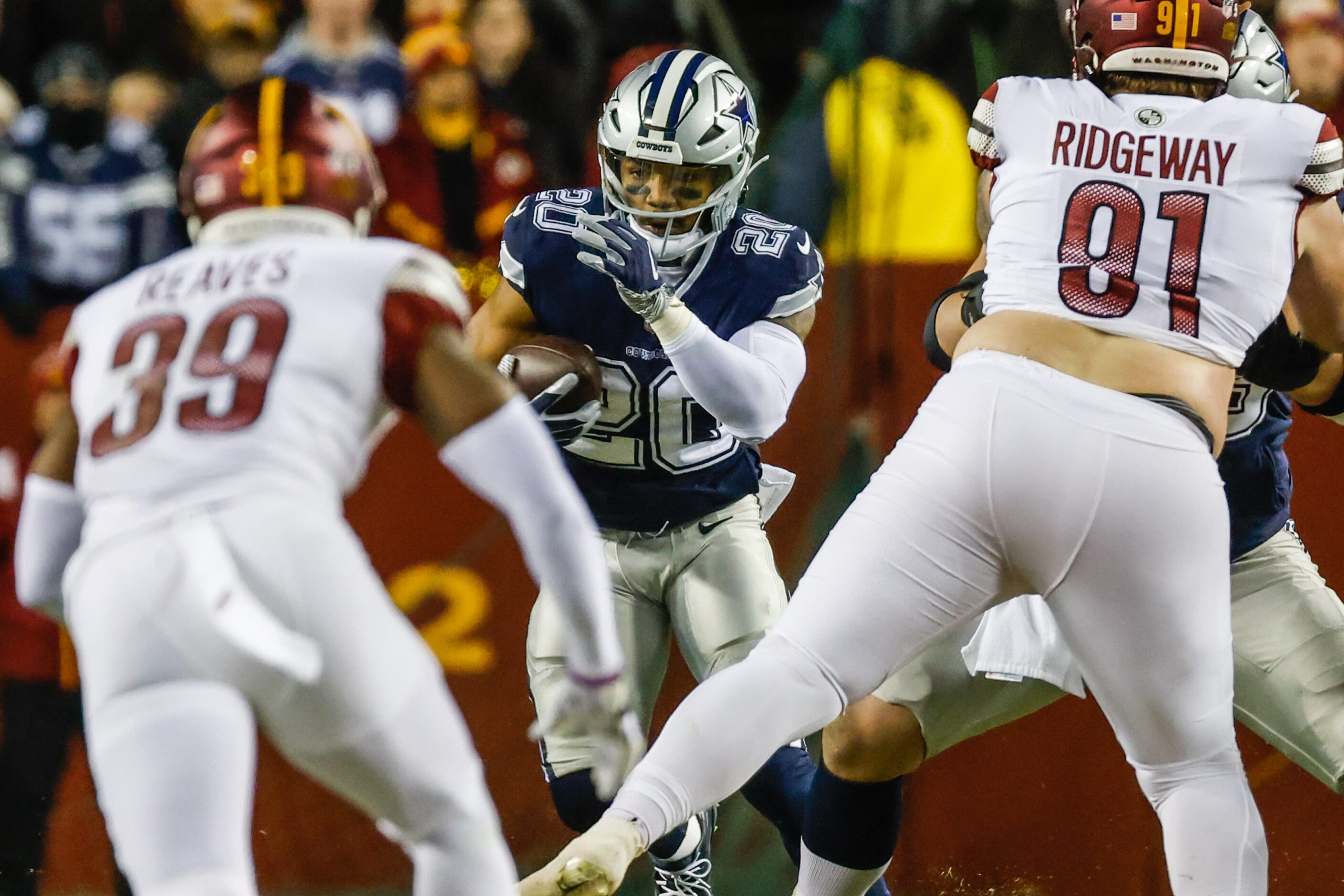 Dallas Cowboys running back Tony Pollard (20) runs with the football during the first half...