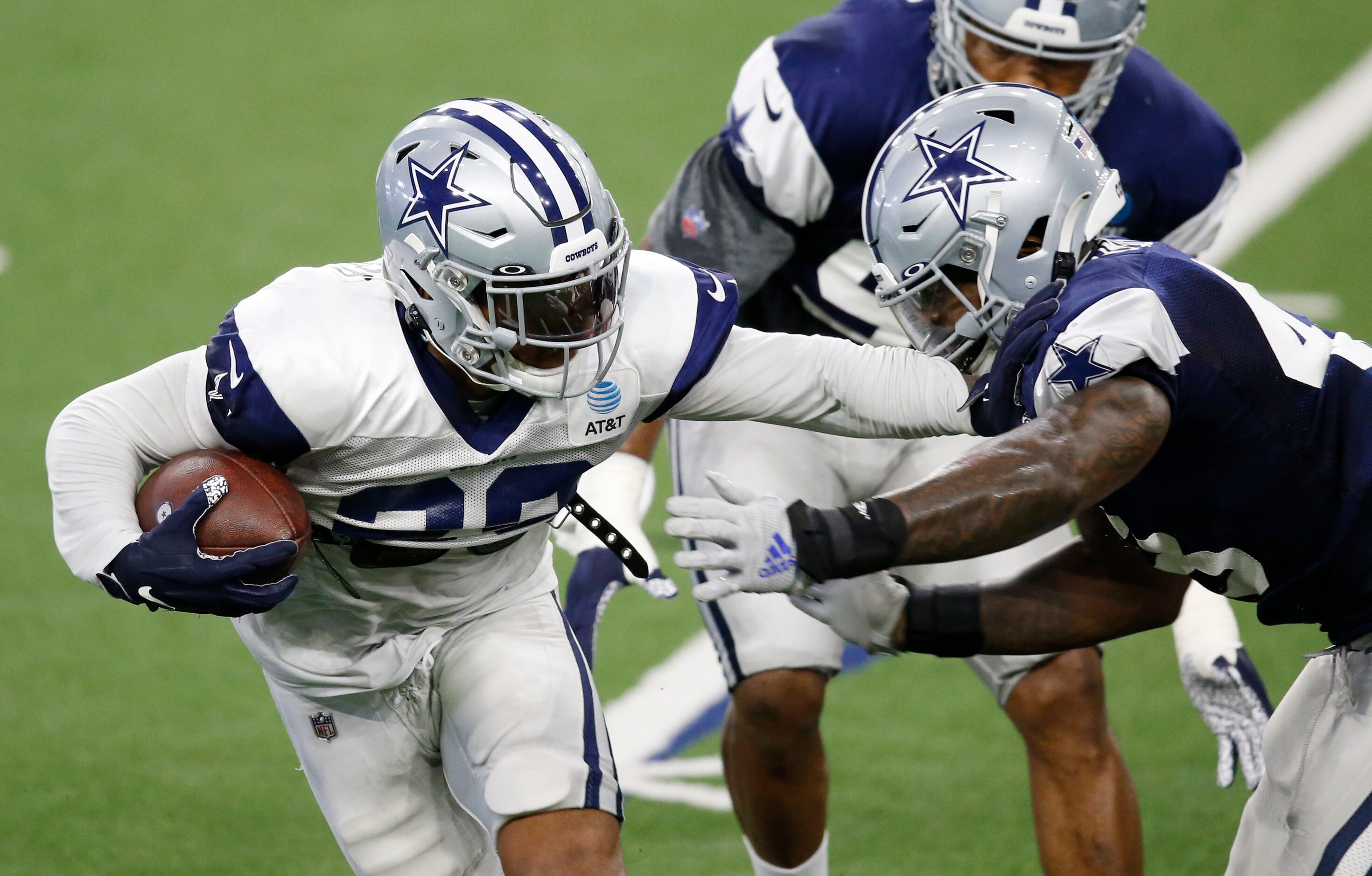 Dallas Cowboys running back Tony Pollard (20) stiff arms Dallas Cowboys linebacker Joe...