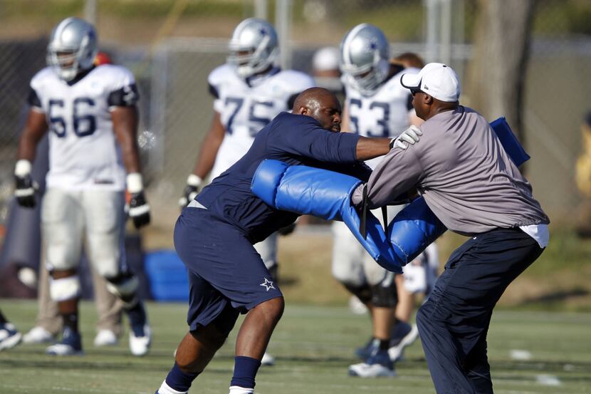 Jay Ratliff (left) works with assistant defensive line coach Leon Lett during drills early...